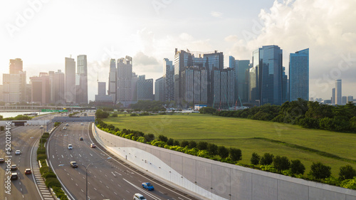 Road with landmark buildings in Singapore, Road to Singapore downtown, Car with Singapore cityscape skyline during sunset.