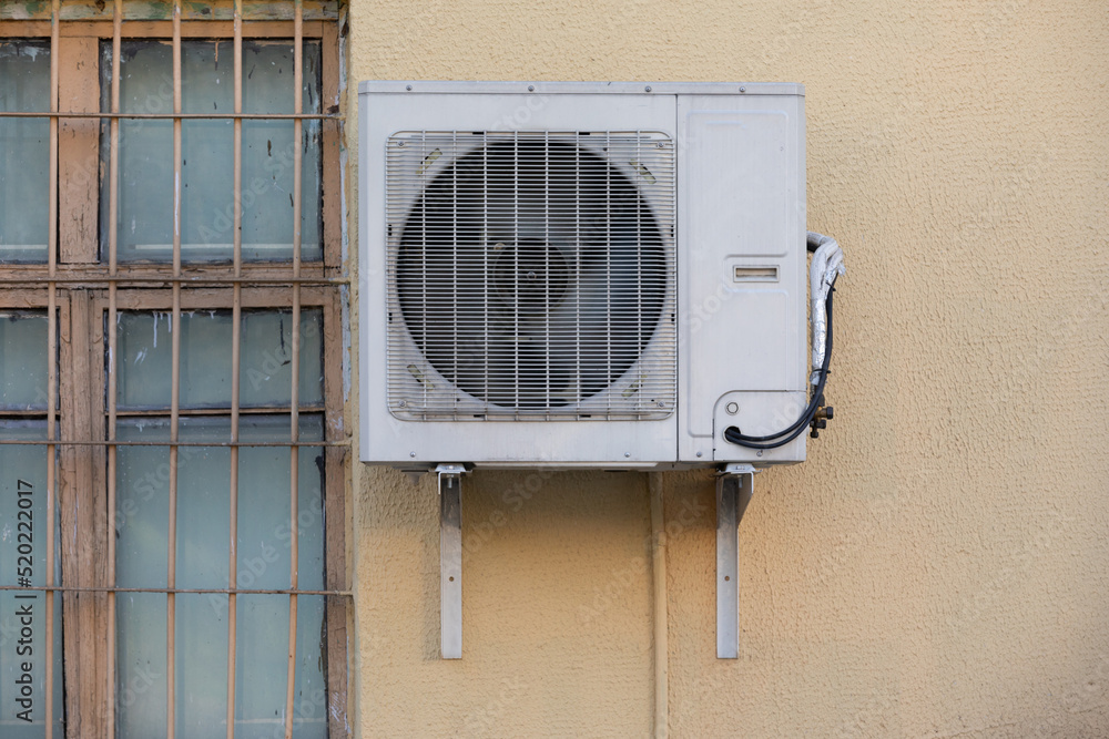 old outdoor air conditioner unit hanging outside the building old outdoor air conditioner unit hanging outside the building