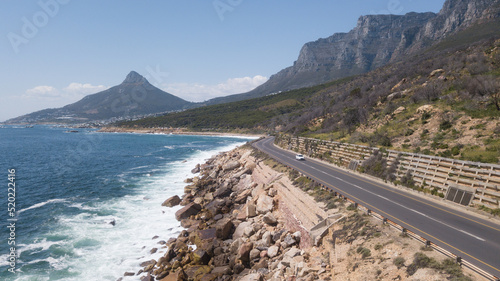 Chapman's Peak Drive with Lion's Head and mountains in the background. Cape Town, South Africa.