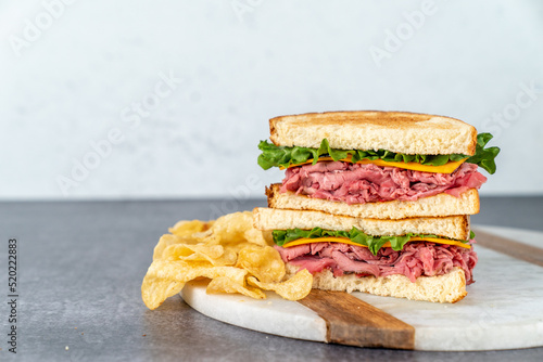 Deli sandwich with drink on a light surface