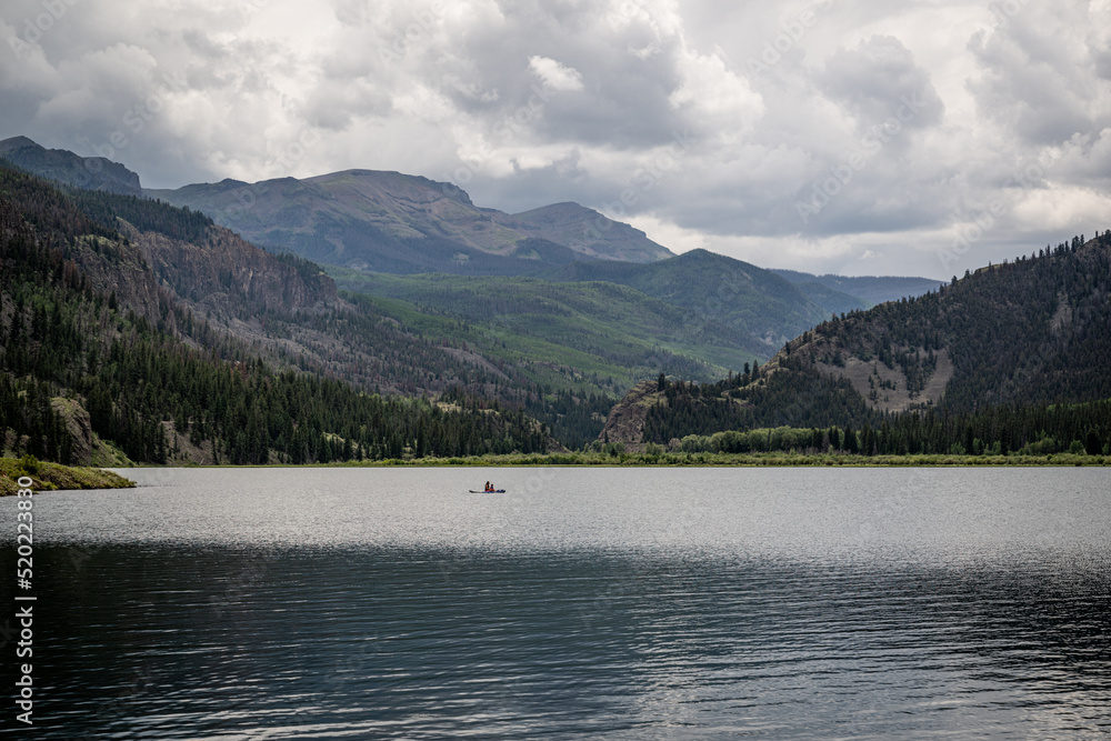 solo kayaker on a mountain lake