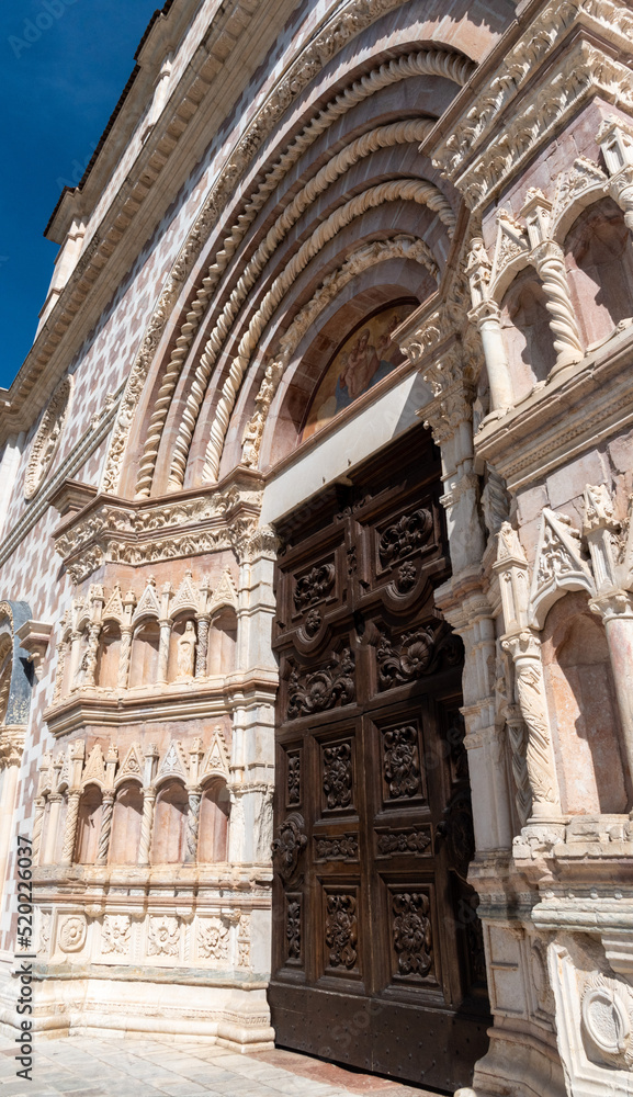 Ornate front gate of the rebuilt Romanesque basilica di Santa Maria di Collemaggio in L'Aquila, Italy