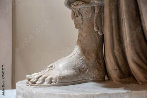 Foot of an ancient Roman scuplture representing a Roman emperor photo
