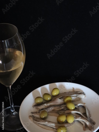 delicious appetizer of anchovies in vinegar with olives and wine