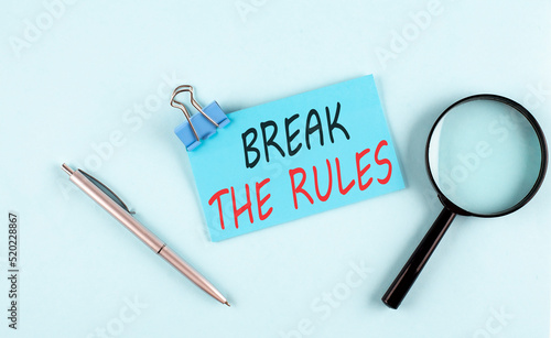 BREAK THE RULES text written on sticky with magnifier and pen, business concept