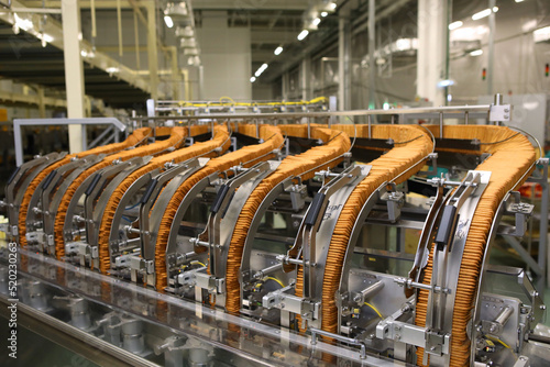 A lot of cookies on the production line. The flow of sweets before packaging. Packing crackers on the machine. Innovative production.