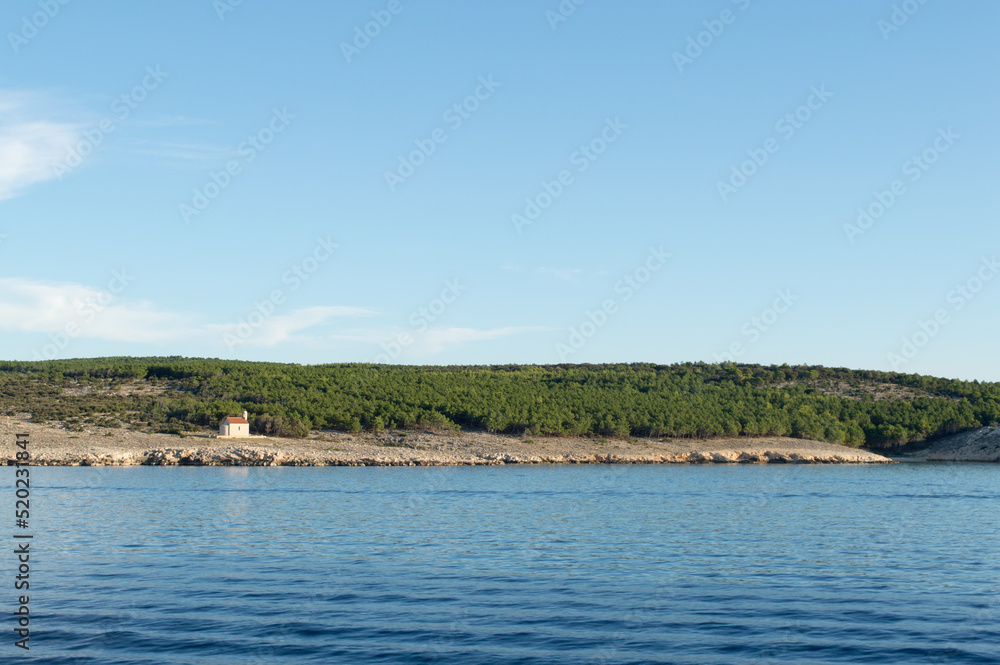 Adriatic coast near town Lopar with isolated catholic church St Nicholas on the island Rab, summer holiday destination in Croatia