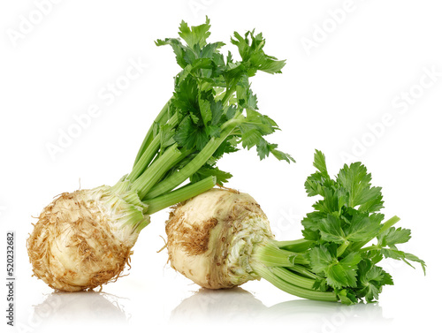 Fresh celeriac root with celery stalks isolated on white background