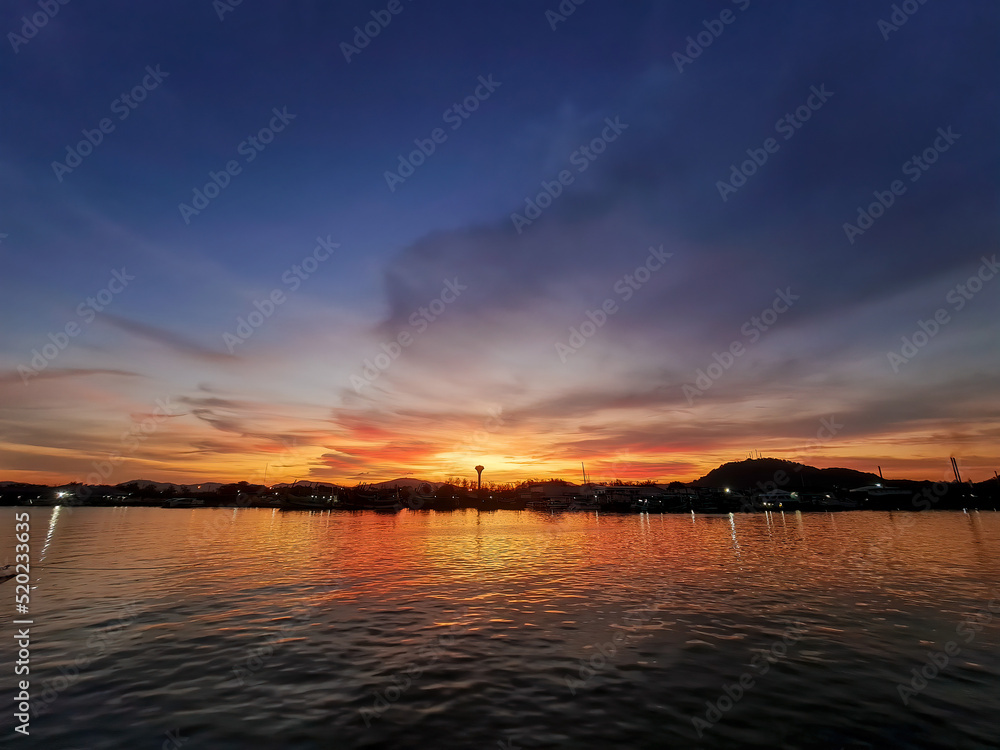 Ocean sea with evening sunset and twilight cloud sky background reflect on water floor landscape in Thailand