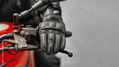 Hand in glove on motorcycle brake handle, free space to insert