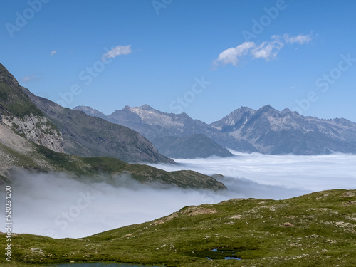 the Cirque de Troumouse (Pyrenees) with cloud filling the valley below and clear blue summer sky