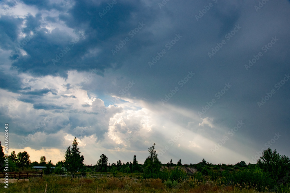 Beam of light through the clouds. Rays of light shining through clouds. Ultraviolet rays concept.