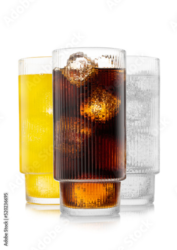 Fotografie Cola soda drink with lemonade and orange soda on white background with ice and bubbles