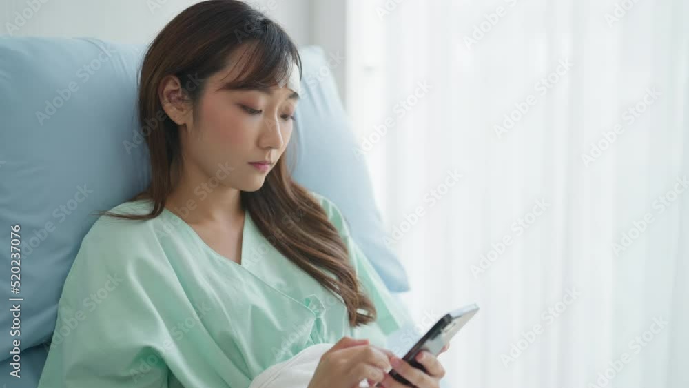 Female Patient using Phone at Hospital Room. Sick Hopeless Young Woman, Distressed Woman Feeling Depressed and Alone and Unhappy. Concept Health Care, Hospital, Medical, Regeneration. Female Patient using Phone at Hospital Room. Sick Hopeless Young Woman, Distressed Woman Feeling Depressed and Alone and Unhappy. Concept Health Care, Hospital, Medical, Regeneration.