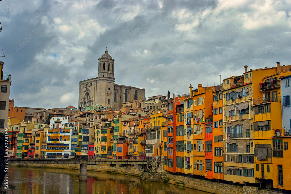 This is the beautiful old city of Girona in Spain, with the Riu Onyar and the cathedral of Girona in the background.