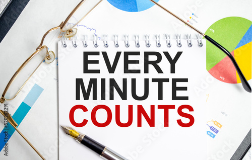 every minute counts word on notepad with glasses and chart