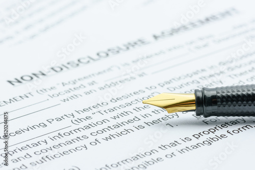 Business legal document concept : Pen on a mutual confidentiality agreement form. Confidentiality agreement is legal contract between 2 or bilateral parties that outlines confidential issues together