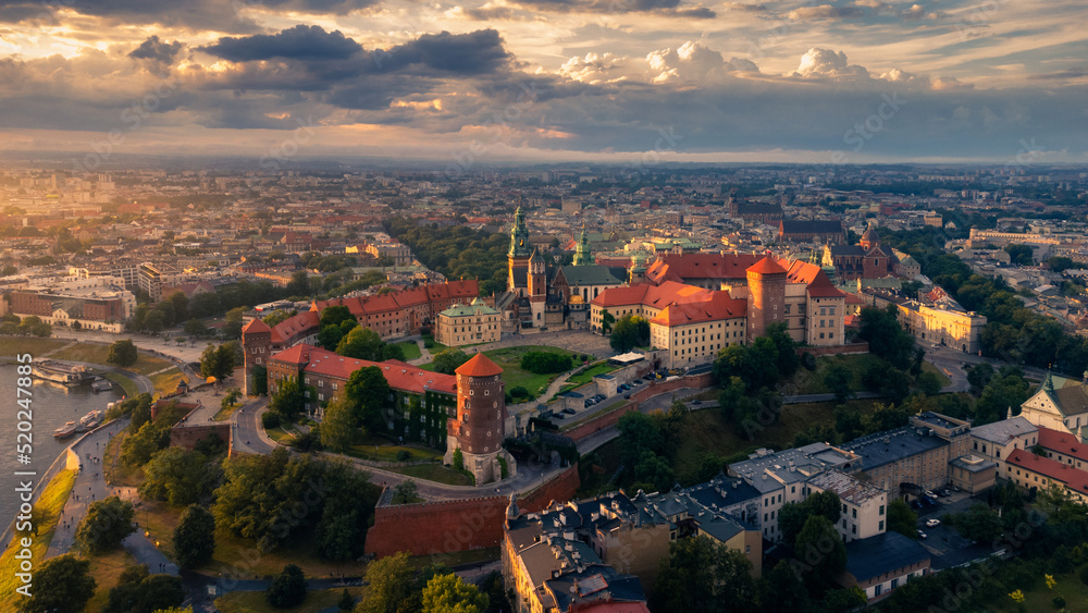 Wawel Royal Castle in Kraków, Poland. This aerial, drone photo was taken during the sunset in a beautiful city which is a popular destination to visit in Europe.