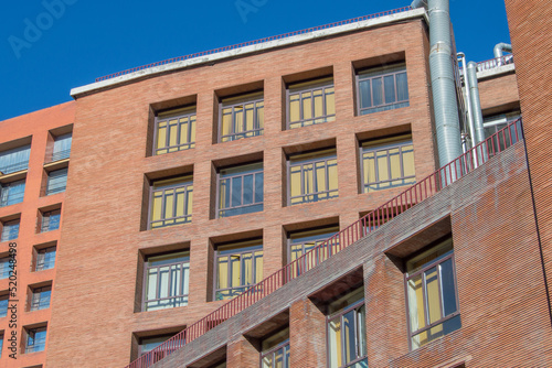 brick facade building with rectangular windows in Madrid. Spain