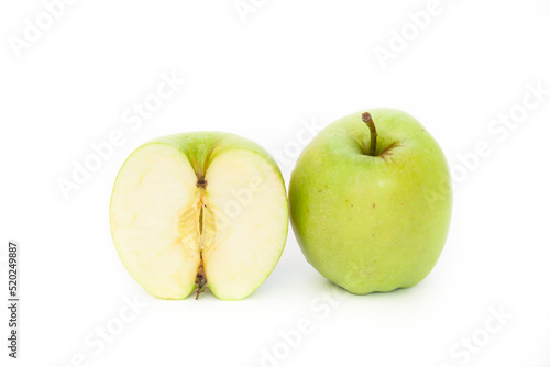 Fresh green apple and a half of an apple in a cut on a white background 