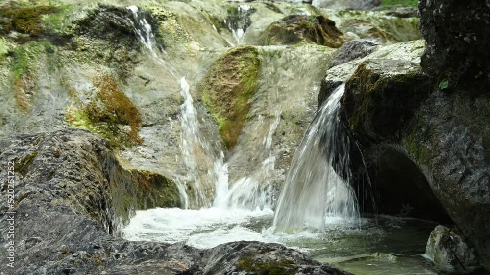 Beautiful and wild waterfalls of a small stream in the mountains with clear and clean water Beautiful and wild waterfalls of a small stream in the mountains with clear and clean water