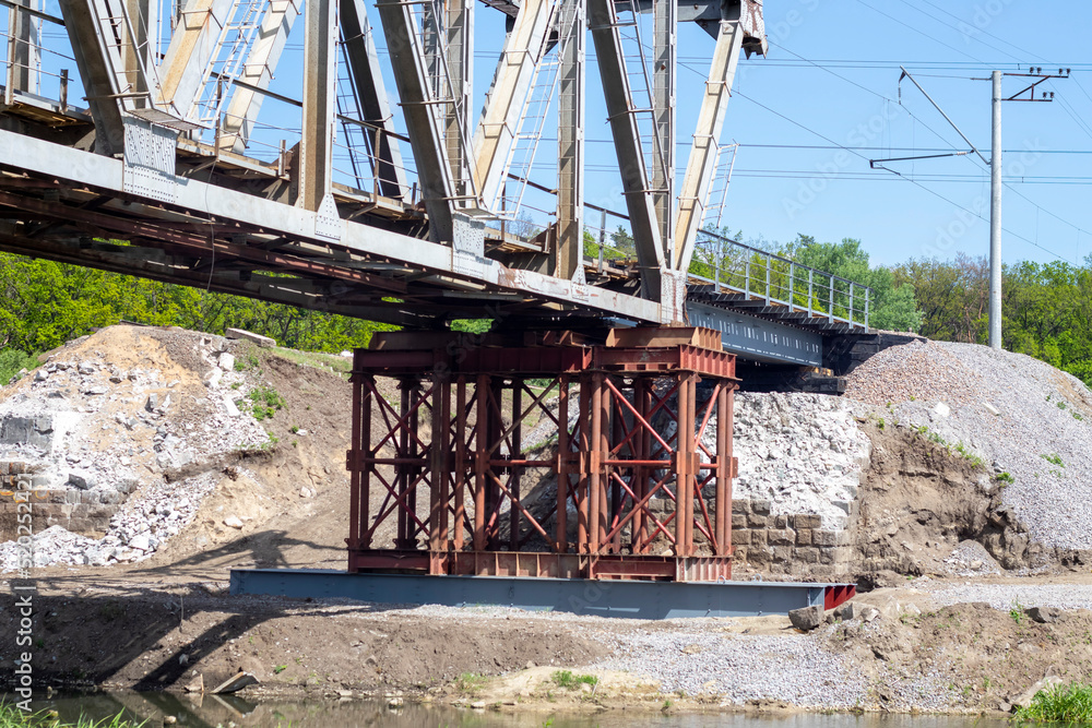 The blown up railway bridge over the Irpen River. War in Ukraine. Panorama. The city of Irpin in the Kyiv region. The blown up railway bridge over the Irpen River. War in Ukraine. Panorama. The city of Irpin in the Kyiv region.
