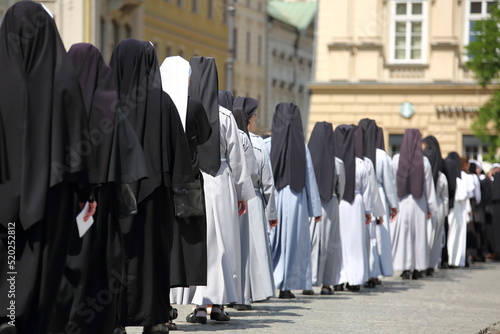 Nuns while join Corpus Christi procession in Krakow street, Poland