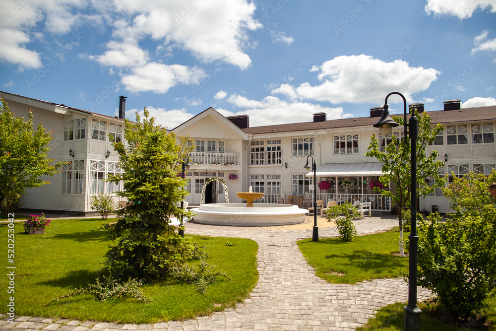 Great large house with green lawns and fountain Great large house with green lawns and fountain