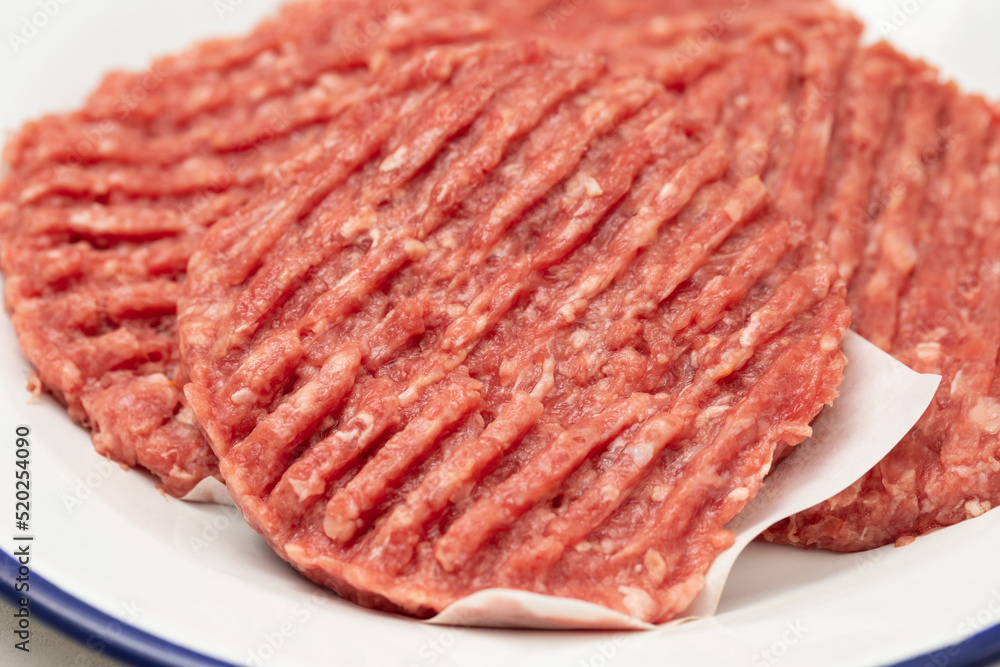 fresh raw minced meat on white dish with paper fresh raw minced meat on white dish with paper