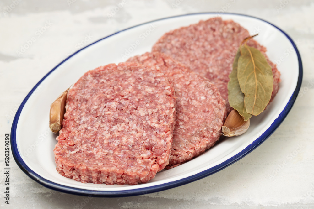 fresh raw minced meat on white dish on dish