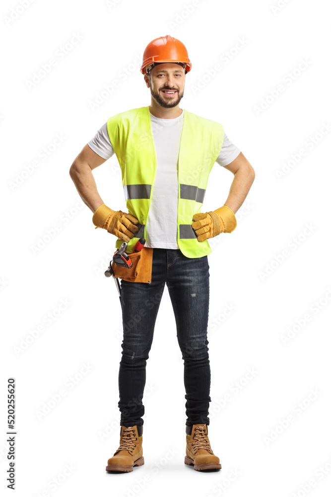 Full length portrait of a site engineer wearing a tool belt and smiling at camera Full length portrait of a site engineer wearing a tool belt and smiling at camera