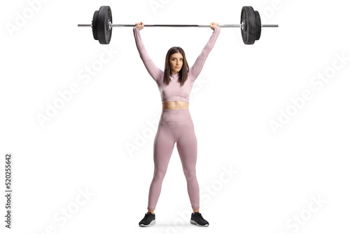 Full length portrait of a strong young woman exercising weight lifting