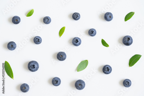 Blueberry pattern on white background. Bilberry berries with green leaves. Top view.