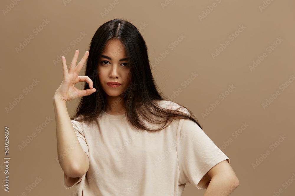 Brunette attractive look charmin in a t-shirt isolated background Brunette attractive look charmin in a t-shirt isolated background