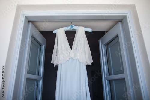 Wedding dress hanging on the door arch