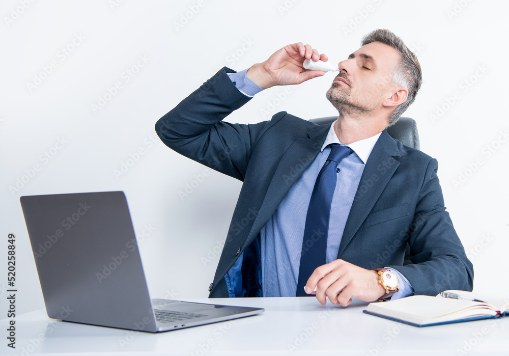 mature man in business office use nasal drops mature man in business office use nasal drops