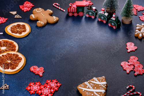 Christmas homemade gingerbread cookies on a dark concrete table