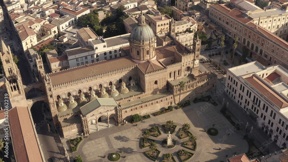 Amazing aerial view of the beautiful old cathedral and square surrounded by small and large buildings in warm summer day. Action. Gorgeous ancient architecture