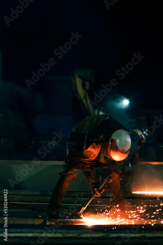 unrecognizable worker cutting steel