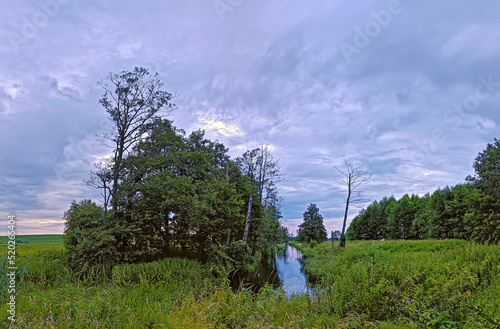 Obraz na płótnie Storm Rainy weather. Summer overcast sky. Small river in wood. Dramatic landscape, cloudy day w salonie