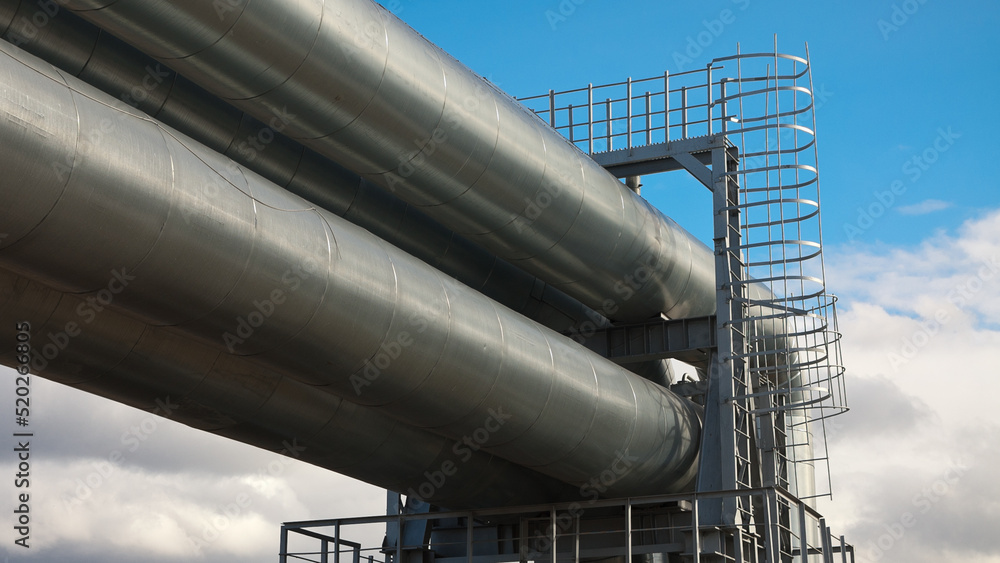 pipeline, in the photo pipeline close-up against a background of green forest and blue sky. pipeline, in the photo pipeline close-up against a background of green forest and blue sky.