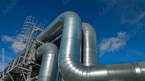 pipeline, in the photo pipeline close-up against a background of green forest and blue sky.