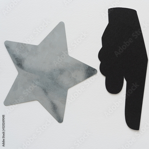 metal star and pictographic glyph (hand with pointing finger) photo