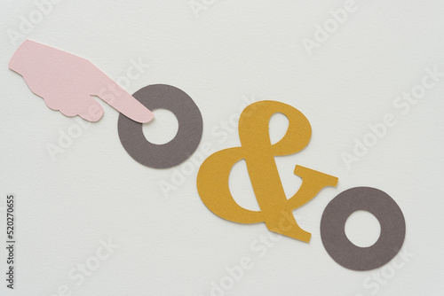 manicule or typographic mark (hand with extended index finger pointing) with ampersand and two rings photo