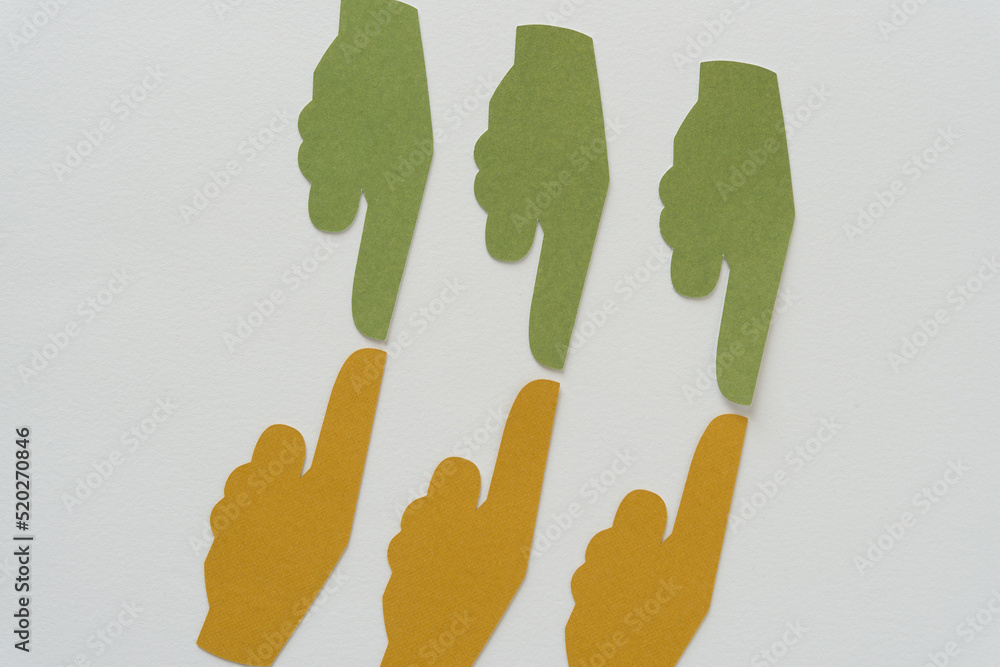 Obraz premium green and yellow paper manicules or typographic marks (hand with extended index finger pointing) on blank paper