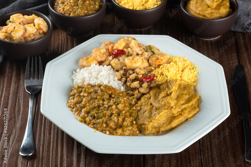 Caruru. Traditional Afro-Brazilian dish made with okra and dried shrimp, accompanied by vatapa, beans, rice, shrimp and farofa. Caruru. Traditional Afro-Brazilian dish made with okra and dried shrimp, accompanied by vatapa, beans, rice, shrimp and farofa.