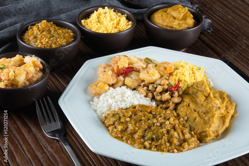 Caruru. Traditional Afro-Brazilian dish made with okra and dried shrimp, accompanied by vatapa, beans, rice, shrimp and farofa.