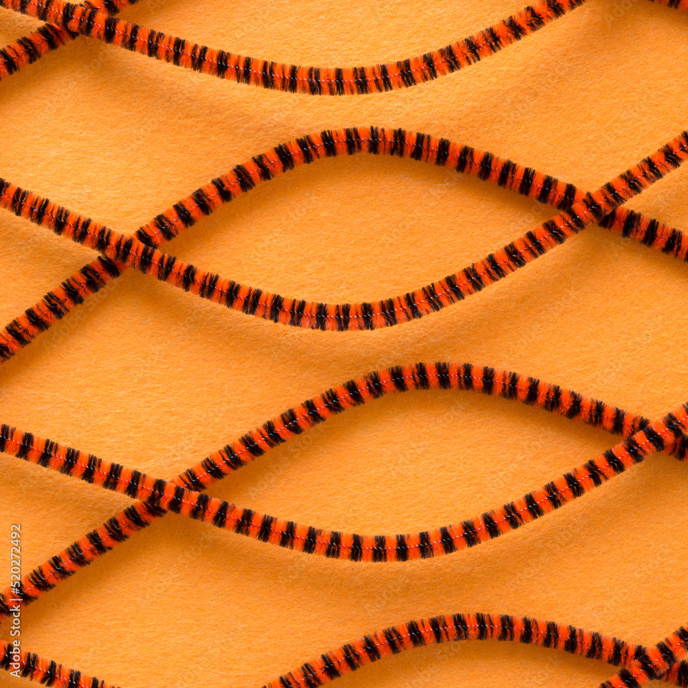 striped orange brown pipe cleaners on orange fabric