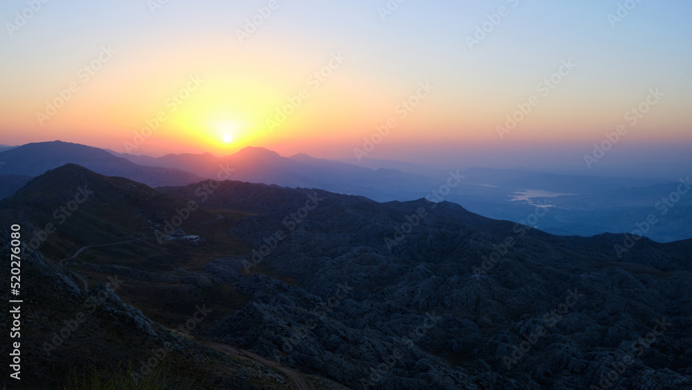 Sun rising above mountain range. Scenic view of sunrise in a mountainside. Nemrut Dagi National Park, Adiyaman province, Turkiye