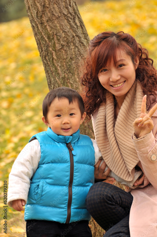 mother and child are playing in garden mother and child are playing in garden